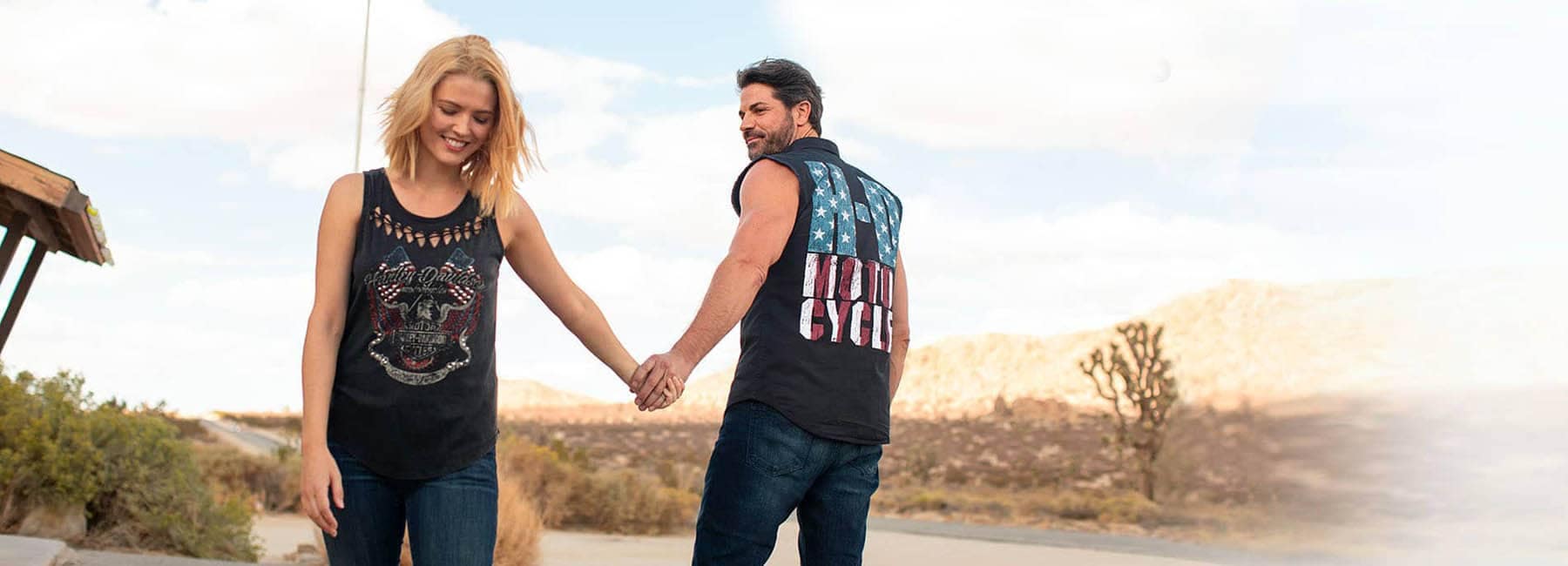 Man and Woman holding hands wearing Harley-Davidson T-shirts